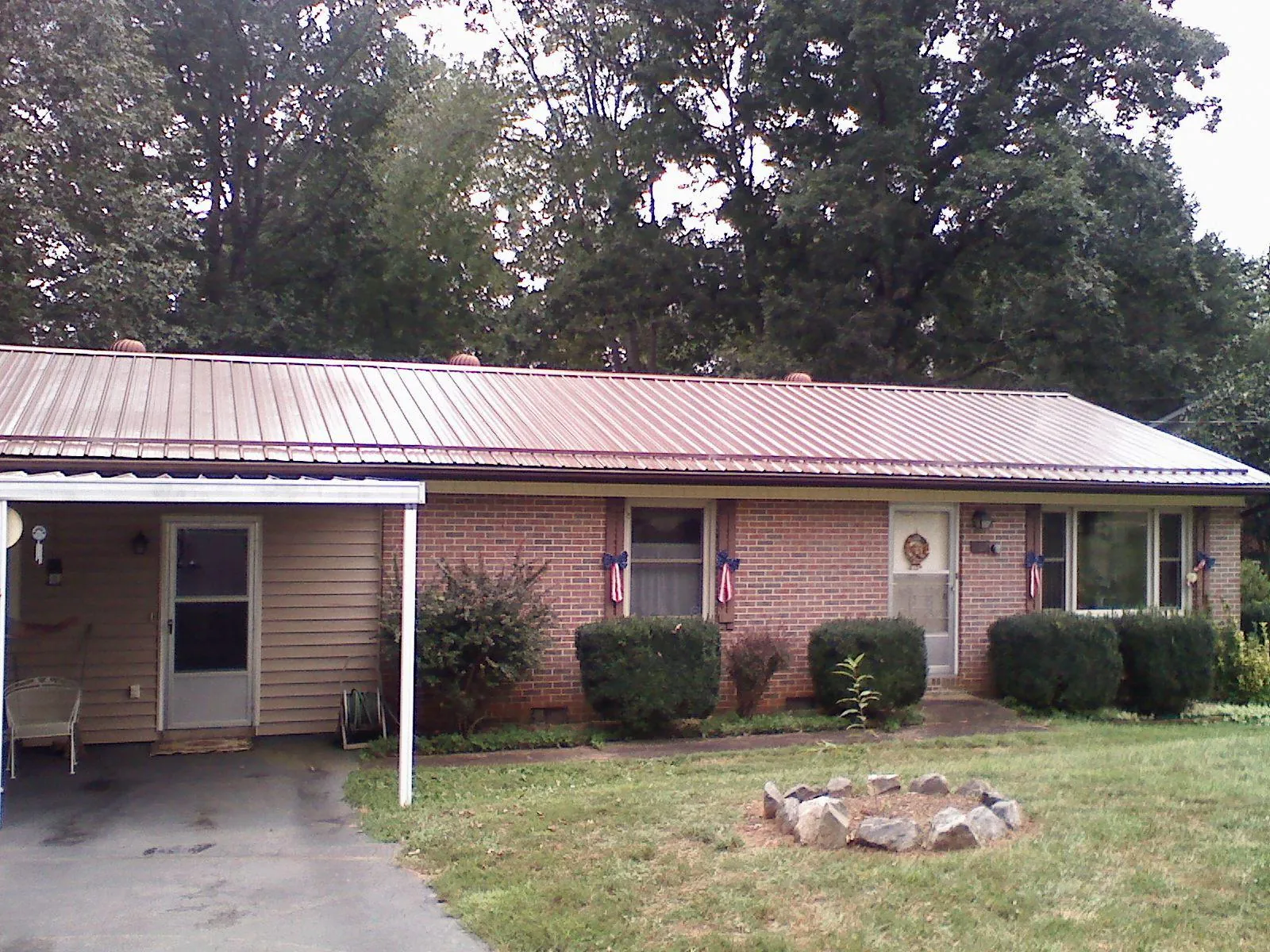 Bronze metal roof and carport on a brick ranch home — Roof Repair work by our crew in North Kingstown